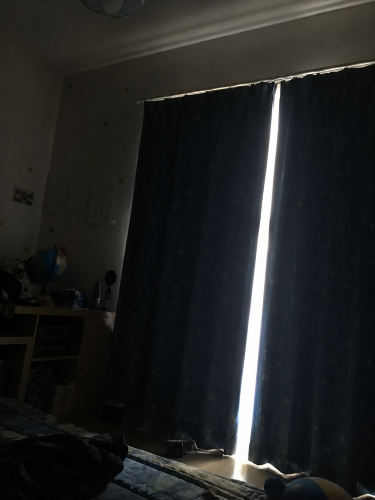 暗い子供部屋にカーテンから光が漏れる